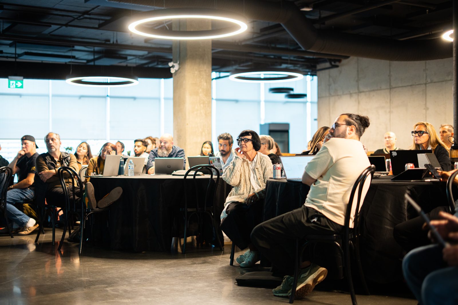 Attendees at Claude 101 Edmonton with laptops open during a live build